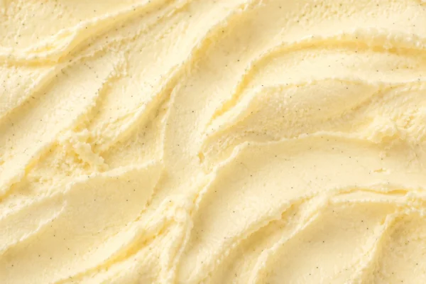 Pale yellow vanilla bean gelato with fine black vanilla specks in a smooth swirl