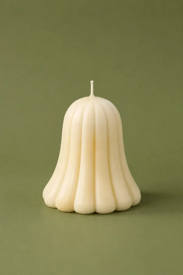 Cream bell-shaped candle with rounded ribs on a muted olive green background