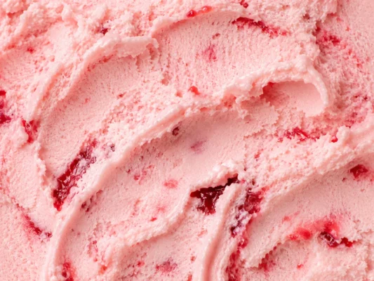 Pink strawberry gelato streaked with red fruit ribbons in a creamy surface