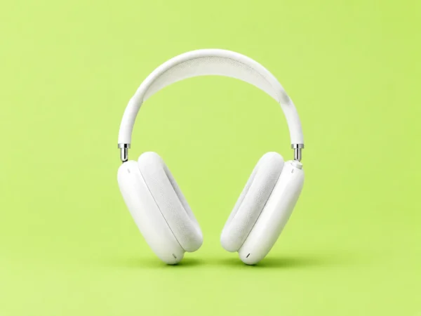 White over-ear headphones floating against a bright lime-green background