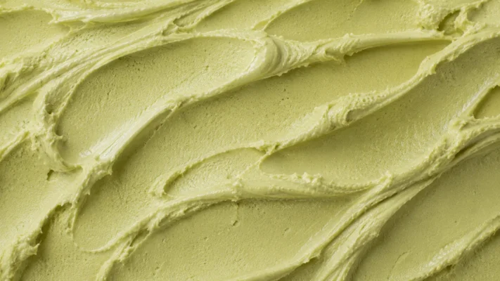 Muted olive-green pistachio gelato with a smooth dense surface texture