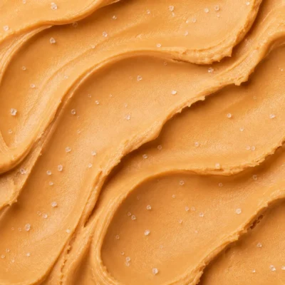 Warm amber-tan salted caramel gelato with a ribbon of caramel swirled through