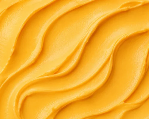 Warm golden-orange mango gelato in a smooth creamy swirl close-up