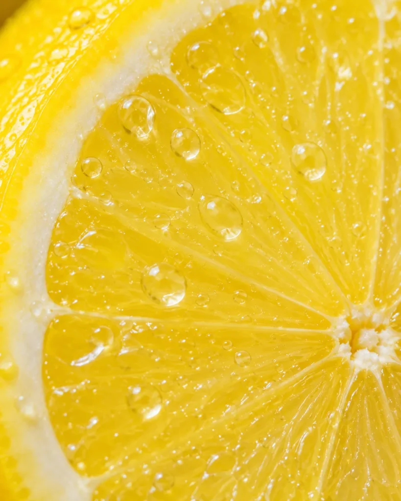Macro close-up of a lemon slice with water droplets on the bright flesh