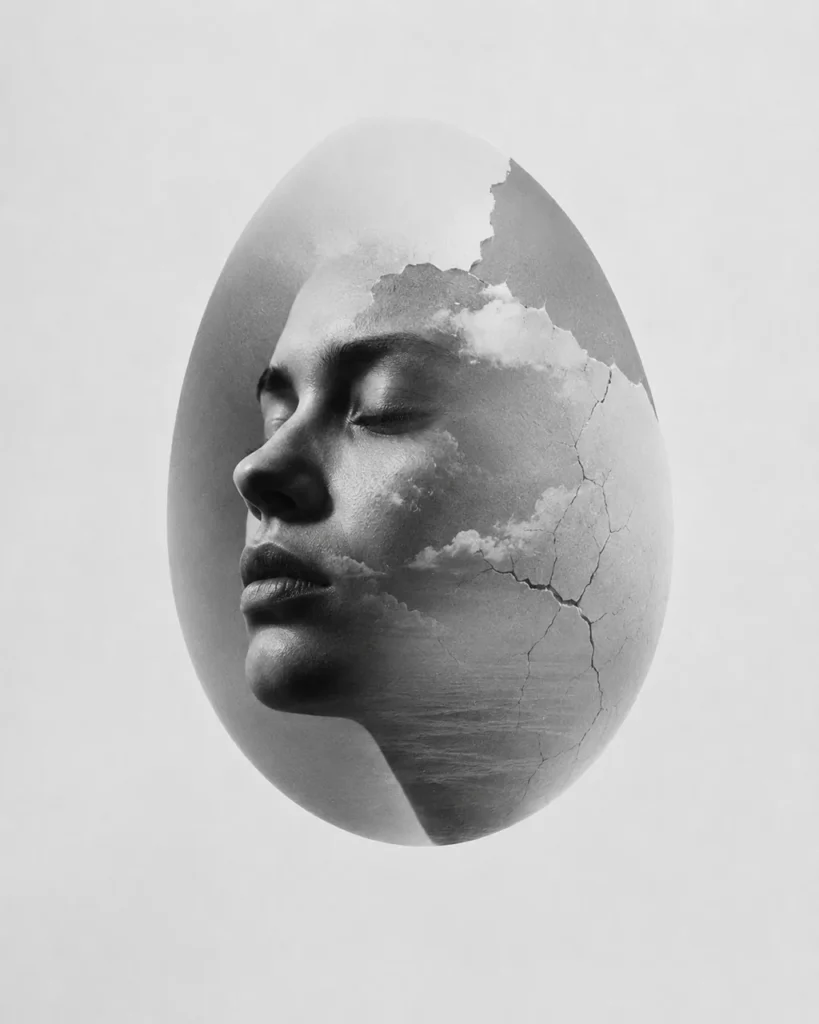 Double exposure of a woman's profile and a cloudy seascape contained within an egg shape